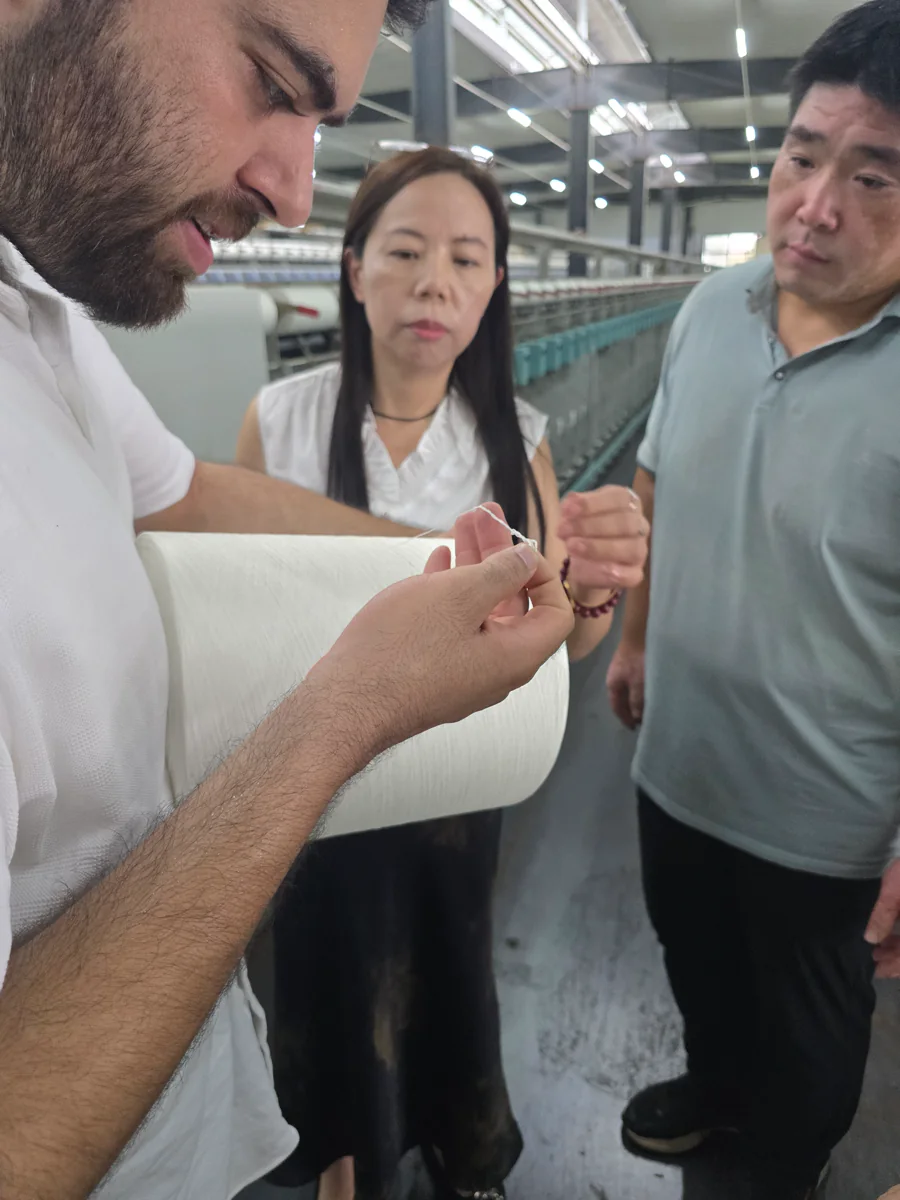 Nexus Supply Chain reviewing product material with a manufacturer in a China factory