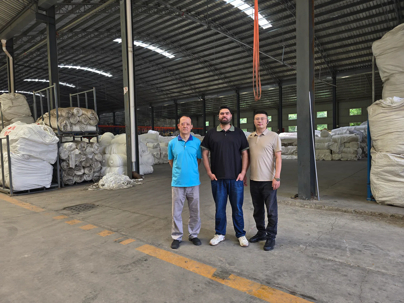 Nexus representative with a supplier team on a factory production floor in China